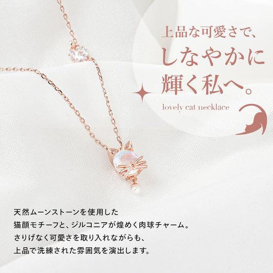 ロースゴールドの猫顔ペンダントを首元に着けたアップ。「上品な可愛さで、しなやかに輝く私へ。lovely cat necklace」。天然ムーンストーンの猫顔モチーフとジルコニアの肉球チャームを紹介