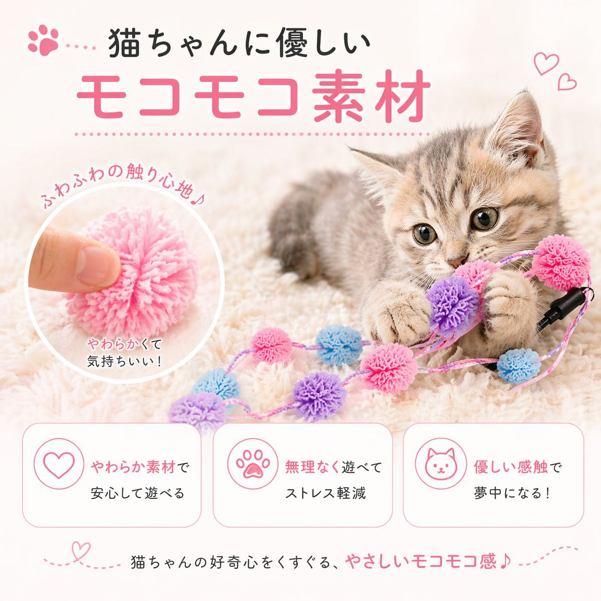 毛布の上でポンポンに前脚を乗せる子猫と、指でつまむポンポンの拡大写真。「猫ちゃんに優しいモコモコ素材」「やわらかくて気持ちいい！」の説明と、安心して遊べる・ストレス軽減・優しい感触の3特長を掲載