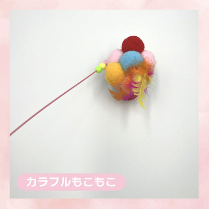 「カラフルもこもこ」ラベル付きのパーツ単体。赤・青・ピンク・オレンジ・黄色のポンポンを束ねカラフルな羽を添えた先端パーツ