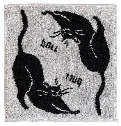 白地に黒猫が伸びをする柄のタオル。「ball」「purr」の文字入り