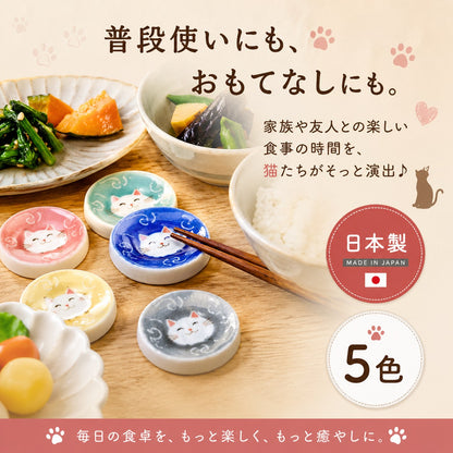 「普段使いにも、おもてなしにも」の見出し。和食が盛られた食卓に5色の猫箸置きを並べ、青い箸置きに箸を乗せた様子。家族や友人との食事を猫たちが演出すると紹介、日本製・5色の表記付き