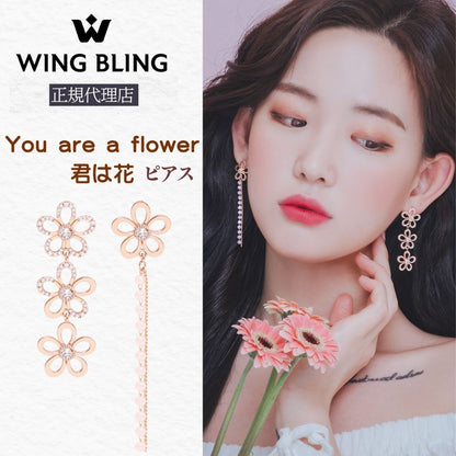 「You are a flower 君は花 ピアス」導入カット。花モチーフを3連に連ねたロングピアスを着けた女性のアップと、ローズゴールドとチェーン付き2種のピアス実物、WING BLING正規代理店の表記