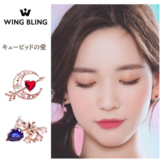 WING BLING「キューピッドの愛」商品トップ画像。左に赤いハートと三日月＆矢モチーフ、青い雫石と星モチーフのイヤリング2種、右に目を閉じて耳元を見せるモデル