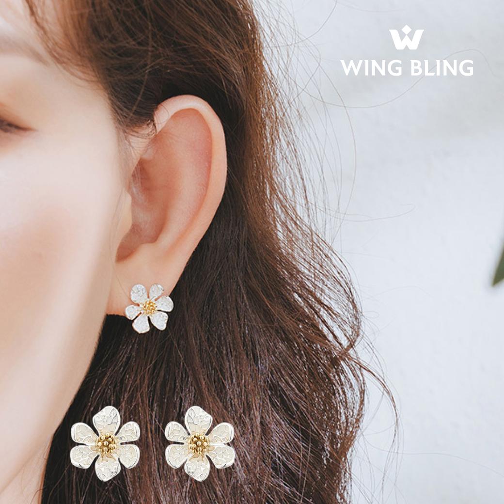 耳に着けた花形イヤリングのアップと、下段に商品単体2個。WING BLINGロゴ入り